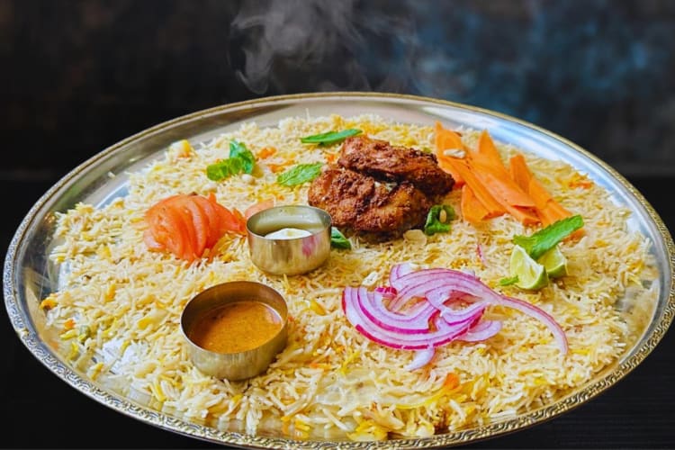 A large rice dish with vegetables and sauces