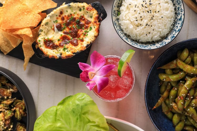 Rice, edamame and a pink drink on a table