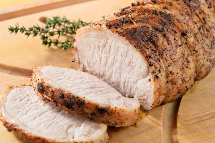A pork roast partially sliced