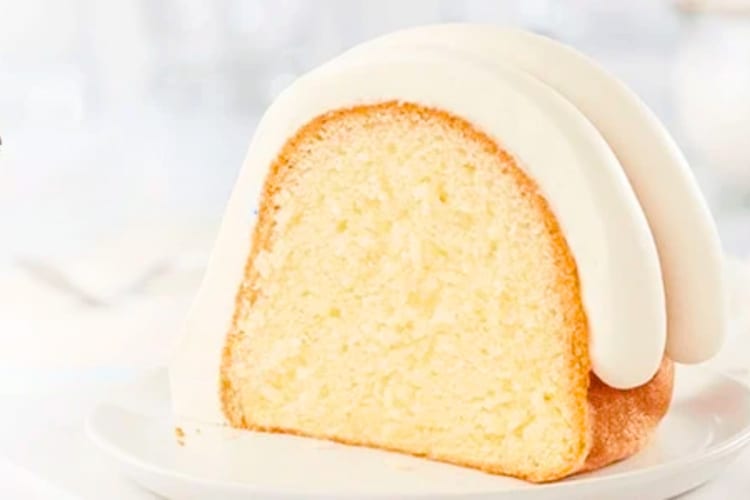 A slice of vanilla bundt cake with frosting