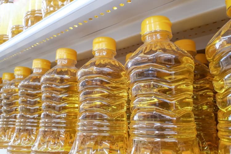 Plastic bottles of vegetable oil on a shelf