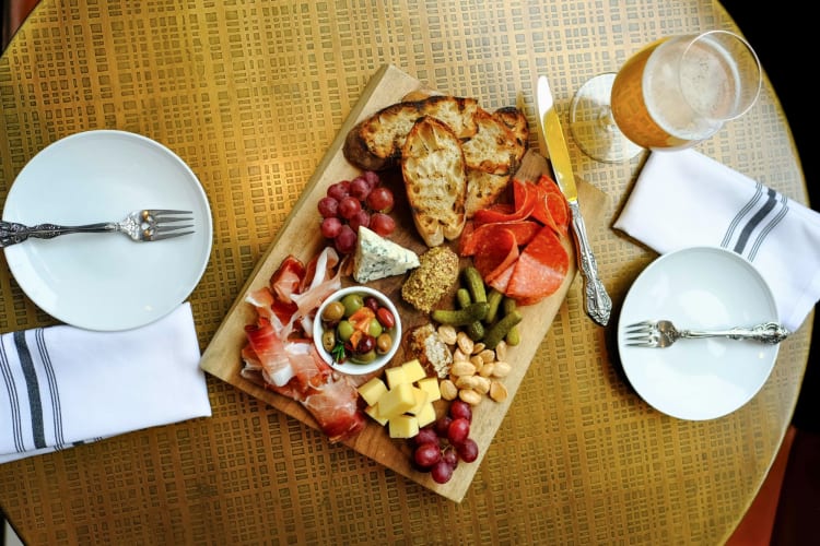 Charcuterie board with cured meat, artisan cheeses and fruits