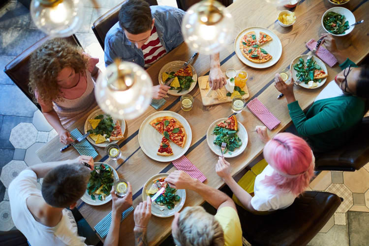 Top-view of six friends eating at a restaurant