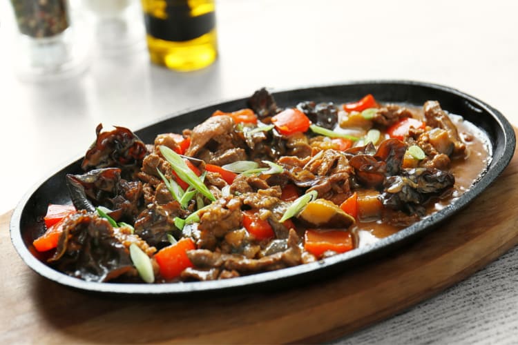 Mushroom ragout served in a black bowl