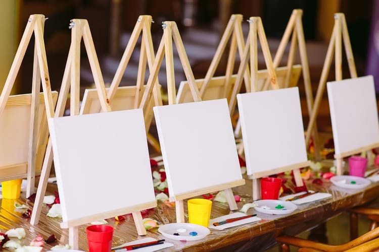 Canvases and art equipment lined up in a row