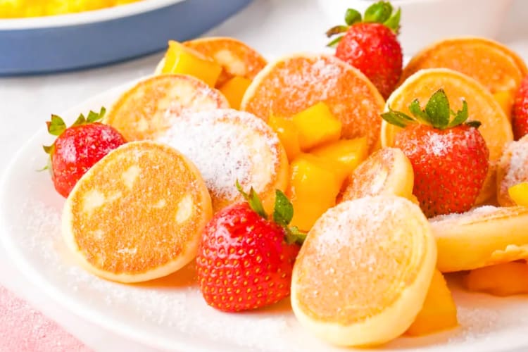 Mini pancakes with fresh fruit on a plate