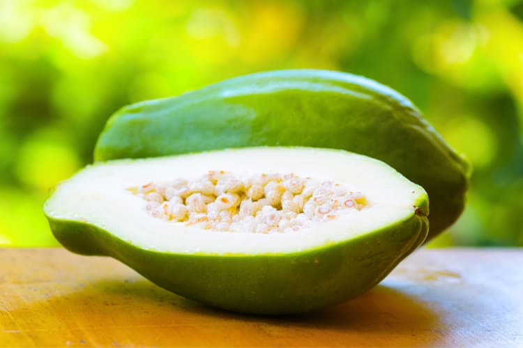 A green papaya cut in half