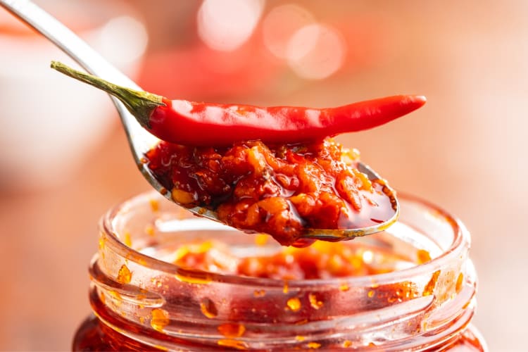 Chile sauce is a good paprika substitute for cooked dishes