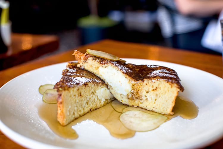 Side-view of two portions of French toast covered in syrup, from Paragary's