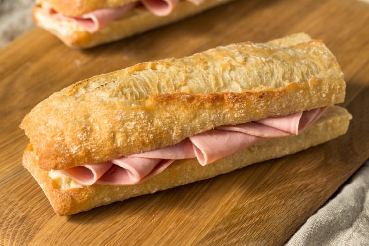 A baguette sandwich with ham and butter