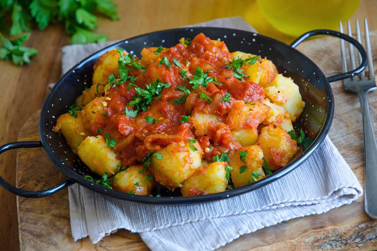 Patatas bravas with tomato sauce and parsley