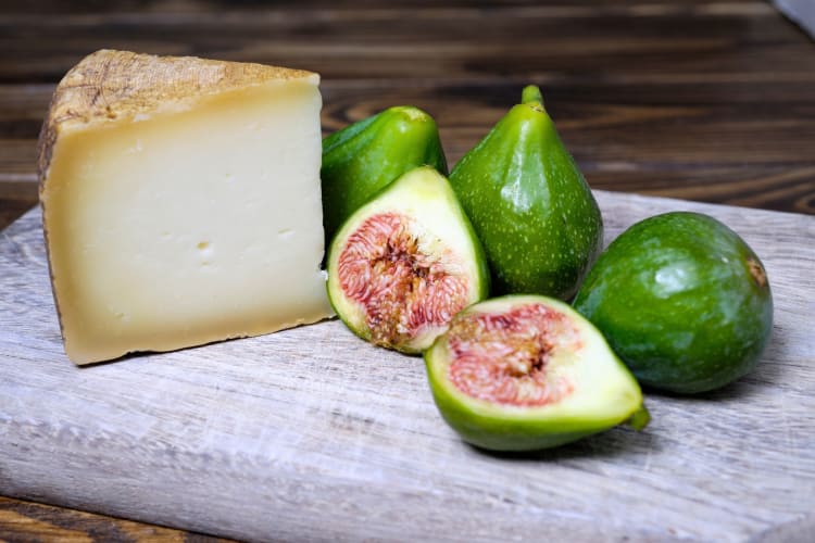 A wedge of pecorino with fresh figs