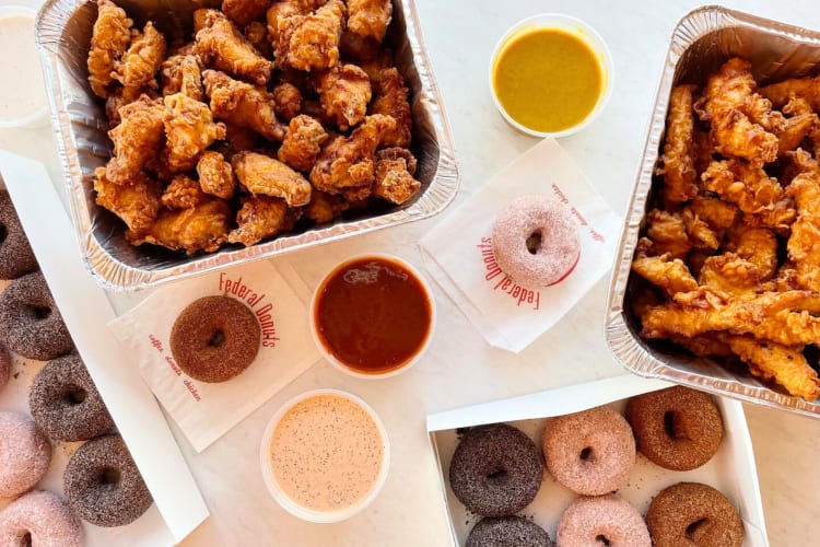 Fried chicken, donuts and sauces on a table