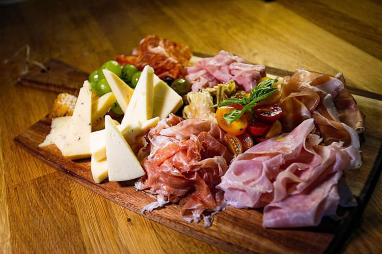 Cheese and ham board with added grapes and tomatoes from Piadina 305