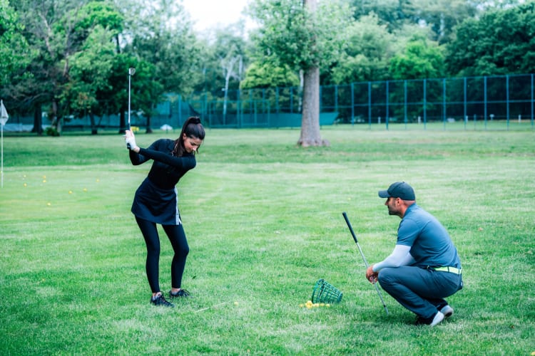 A person having golf lessons