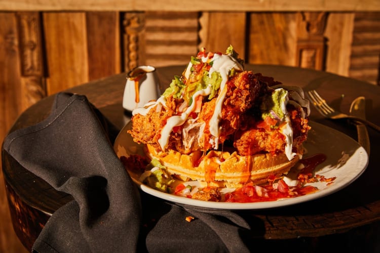 A large portion of waffles and fried chicken.