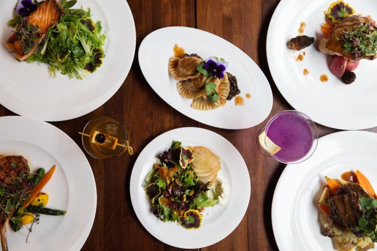 Topview of a spread of food and cocktails. 