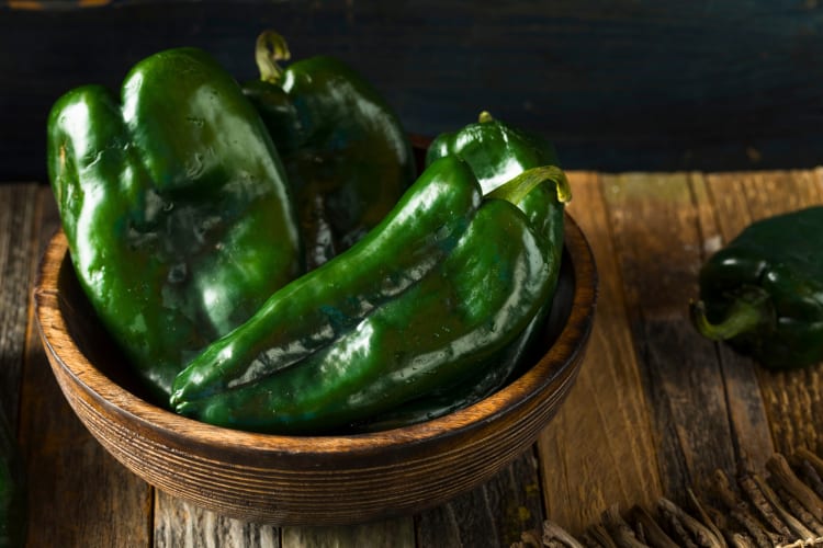 Poblano peppers in a wooden bowl