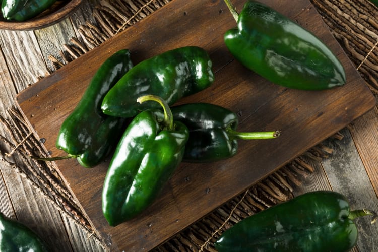 Poblano peppers on a cutting board