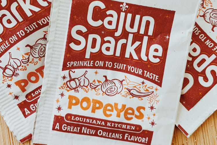 Packets of Popeyes Cajun Sparkle seasoning