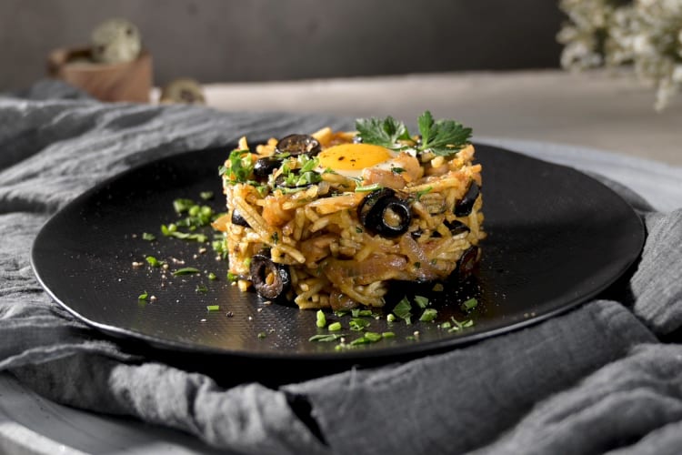 A rice dish with eggs and olives