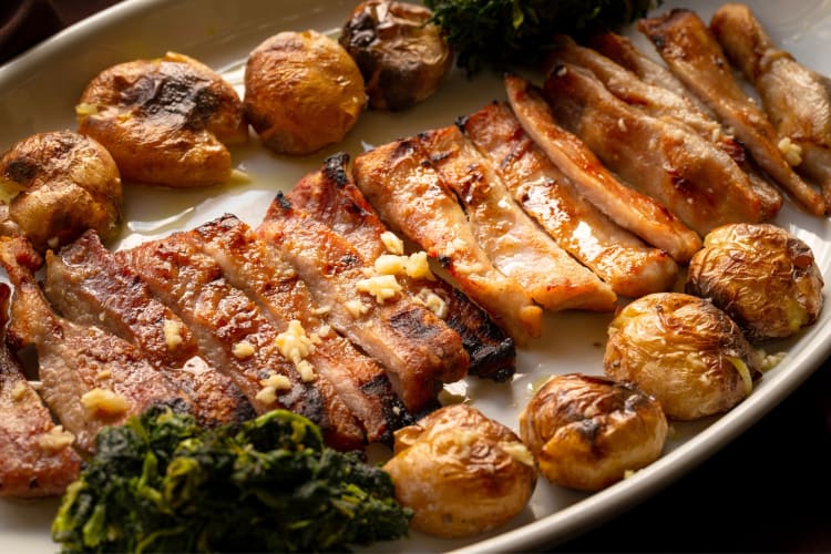 A meat dish with potatoes and spinach