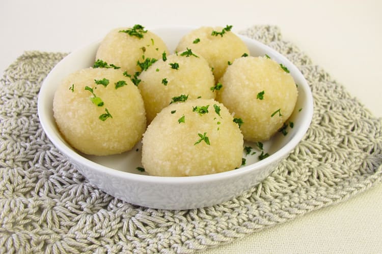 Six potato dumplings in a white bowl