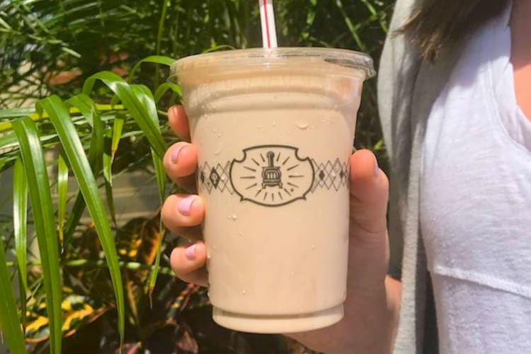 A person holding a chocolate shake from Potbelly