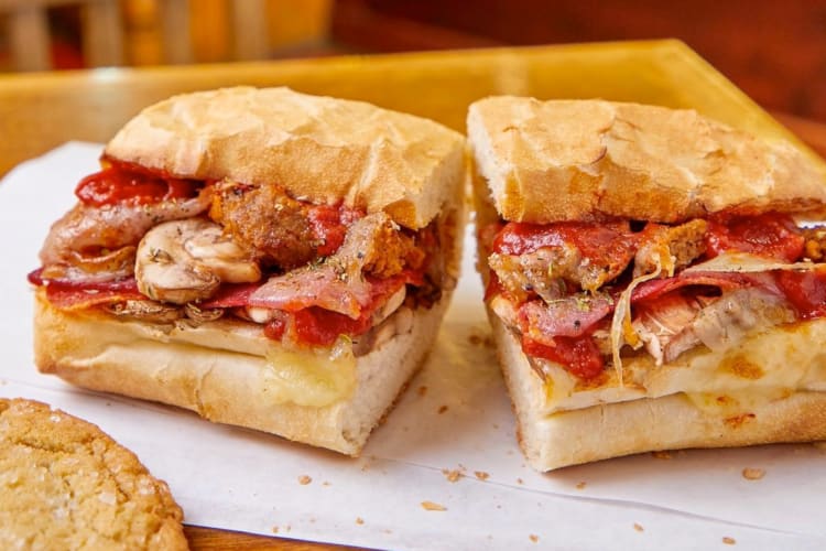 A toasted sandwich with meatballs and mushrooms