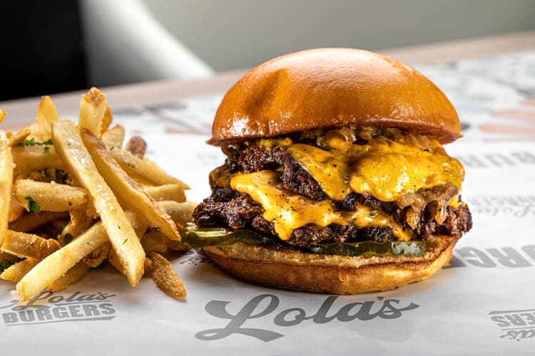 Side view of a burger and fries from Proper Eats Food Hall