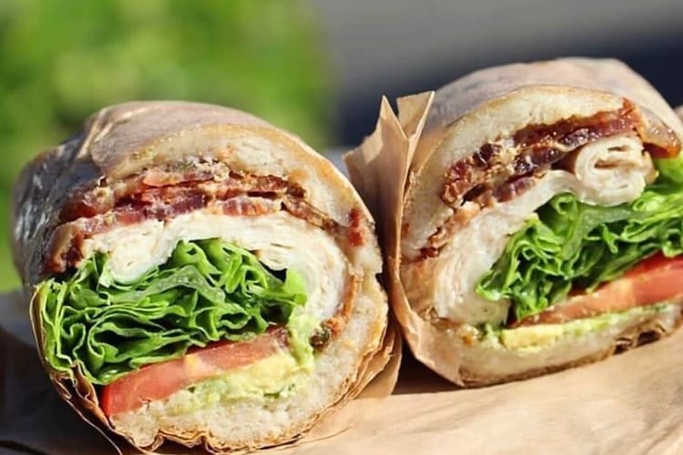 Two halves of a turkey bacon sandwich from Pushkin’s Bakery