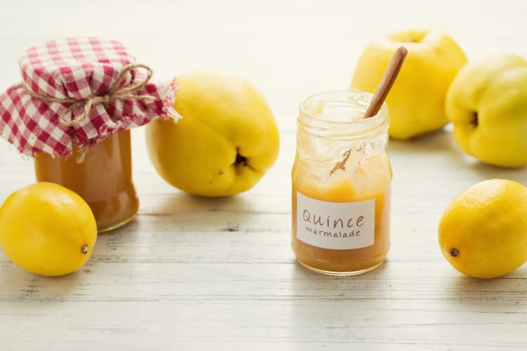 Quince marmalade in jars next to quince