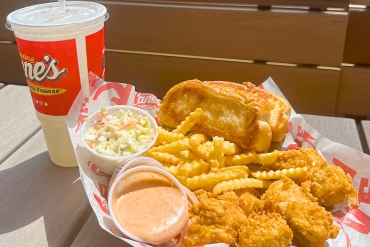 Chicken, crinkle cut fries and Texas toast next to a drink