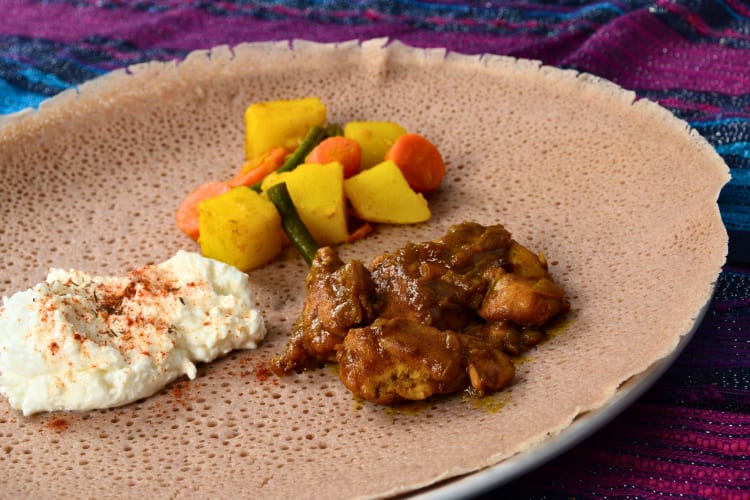 Injera flatbread with meat and vegetables.