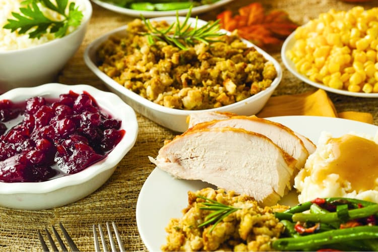 A Thanksgiving meal, including turkey, stuffing and cranberry sauce