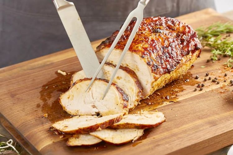 A person carving a piece of meat