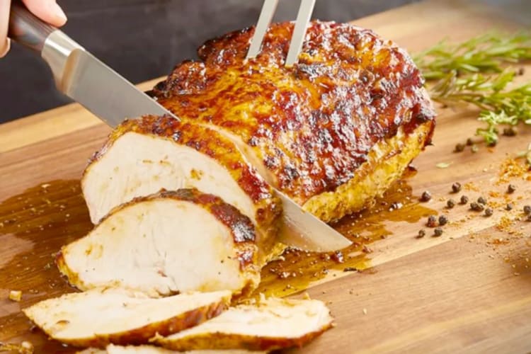 Meat being carved on a board