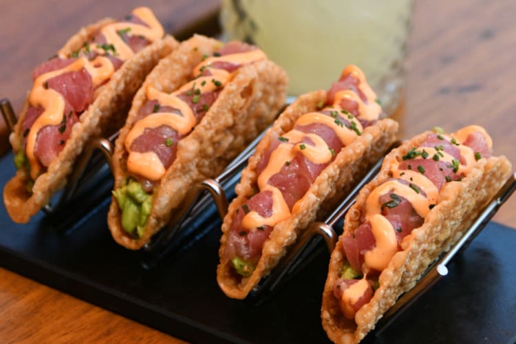 A plate of tuna tacos with fried wonton shells 