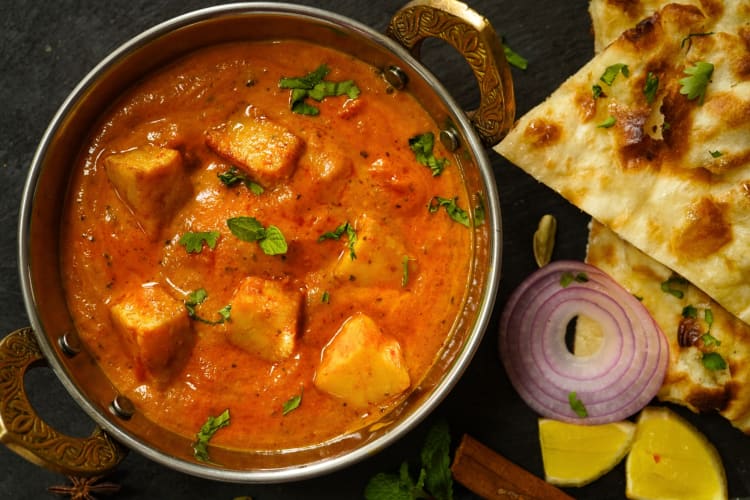 Large metal bowl full of tikka masala