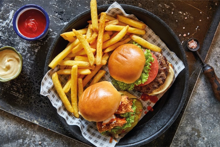 Burgers and fries on a chequered napkin