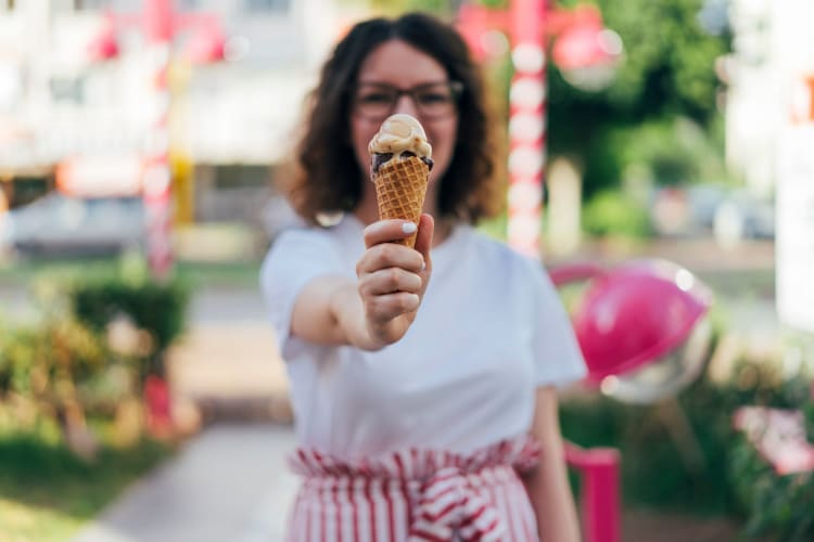 women holding out ice cream