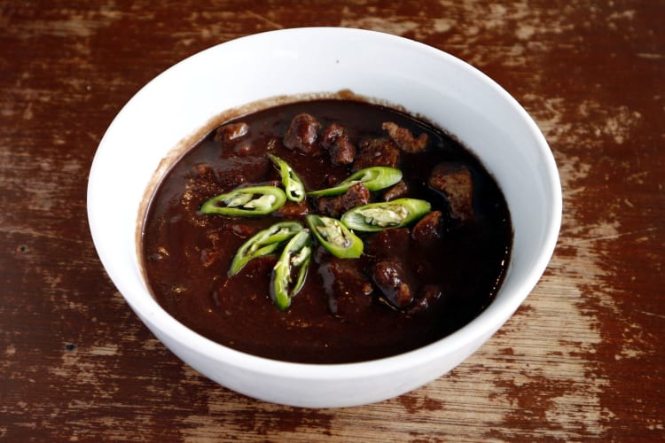 A bowl of dinuguan, a dark colored Filipino food