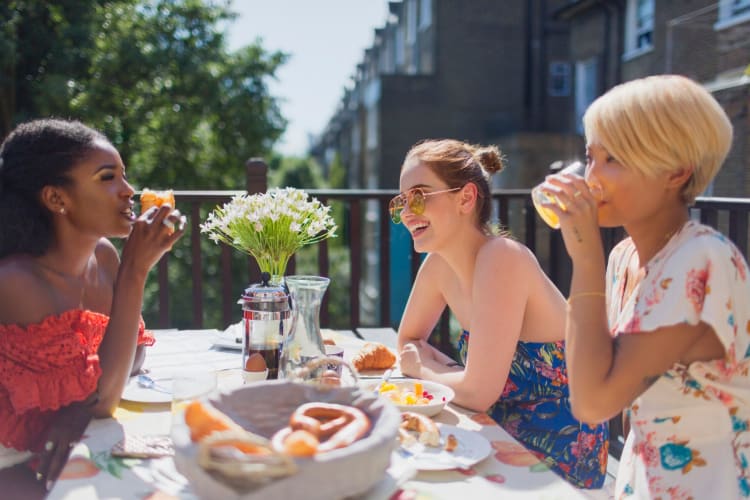 women enjoying brunch outside in the sun