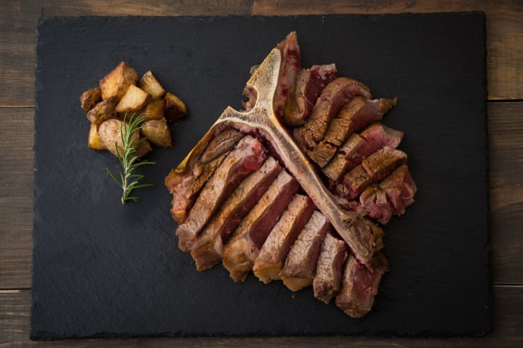 sliced porterhouse steak with bone