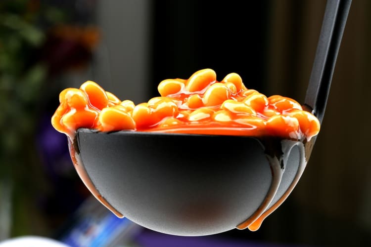 baked beans in a ladle