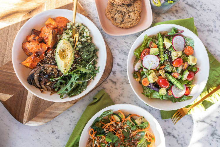 a table with healthy salads and bowls