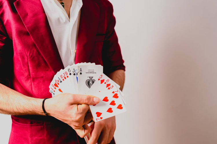 magician with a splayed hand of cards