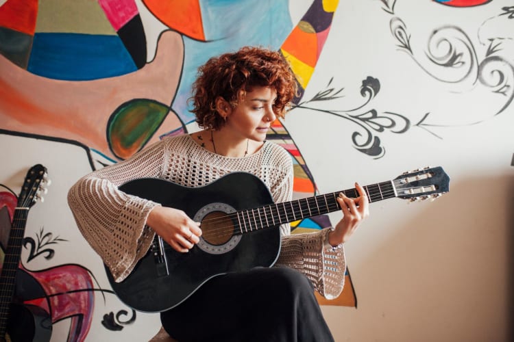 woman playing guitar