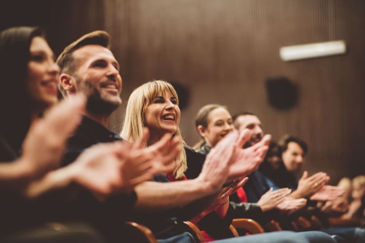 clapping and smiling audience members