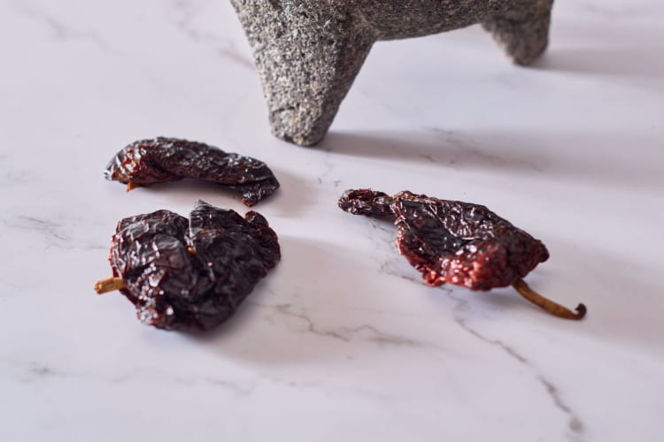 pasilla peppers on a white table